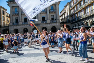 Una remera baila con la bandera en alto y la plaza aplaude alrededor.