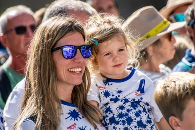 Una mujer con gafas de sol y una niña pequeña, las dos con la camiseta del club.