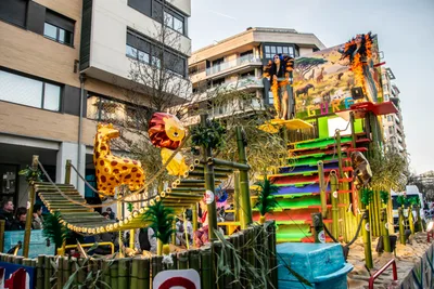 Carroza de selva con jirafas, un león y cañas de bambú de colores.