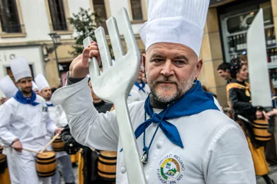 Un cocinero levanta el tenedor gigante con los barriles sonando detrás.